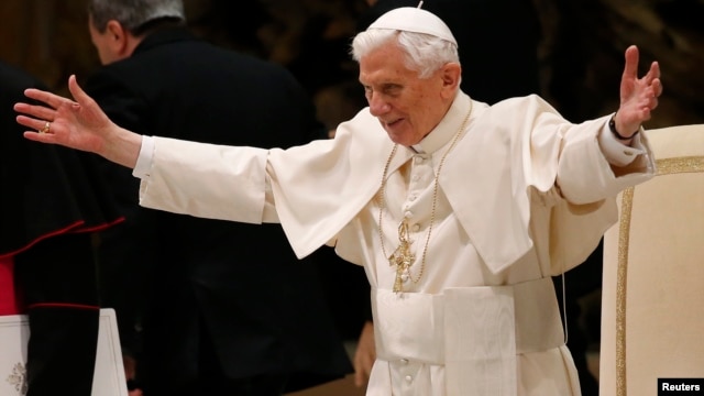 Pope Benedict XVI opens his arms in greetings as he arrives to lead his Wednesday general audience in Paul VI hall at the Vatican, February 13, 2013.