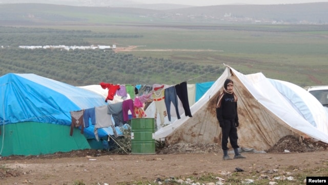 A Syrian refugee looks on in a refugee camp on the Syrian side of the border with Turkey, near Idlib, January 29, 2013.