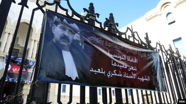 Banners showing assassinated opposition leader Chokri Belaid outside the main courthouse in Tunis. (VOA/H. Ridgwell)