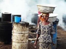 A woman carries fresh produce on her head through the streets of Accra … African farmers don’t have the resources to rapidly transport local food to markets, and so indigenous food types are replaced by imported food in most African supermarkets