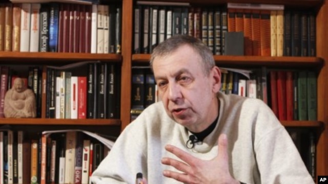 Former presidential candidate Andrei Sannikov speaks during an interview with Reuters at his apartment in Minsk, April 16, 2012. 