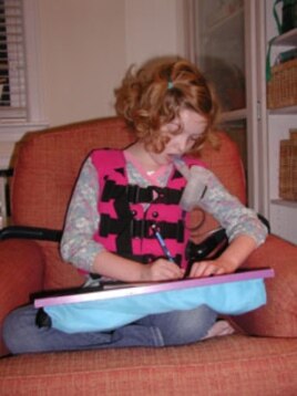 Ava Downs’ twice-a-day therapy involves a vest that vibrates her chest to shake sticky mucus from her lungs.