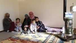 Syrian refugees, who fled the violence in the Syrian town of Qusair, sit at a temporary home, in the hillside town of Arsal in Lebanon's Bekaa Valley, March 5, 2012.