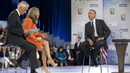 President Barack Obama participates in a town hall hosted by Univision and Univision news anchors Jorge Ramos (L) and Maria Elena Salinas (C), at the University of Miami, Florida, September 20, 2012.