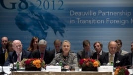 British Foreign Minister William Hague (L) and French Foreign Minister Laurent Fabius (R) listen as U.S. Secretary of State Hillary Clinton speaks during the G8 Deauville Partnership with Arab Countries in Transition meeting in New York, September 28, 201
