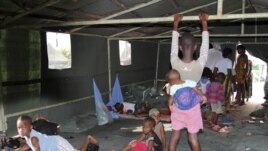 Flood victims wait at a relief center in Igbogene community in Bayelsa state, Nigeria, October 12, 2012.