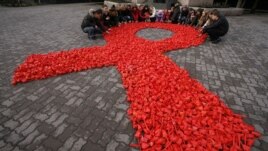 A red ribbon, the symbol of the worldwide campaign against AIDS.