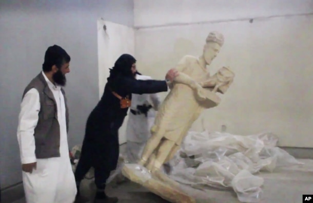 FILE - A five-minute video from the Islamic State group purports to show militants destroying ancient artifacts in Iraq’s Mosul Museum. It was released Feb. 26, 2015.