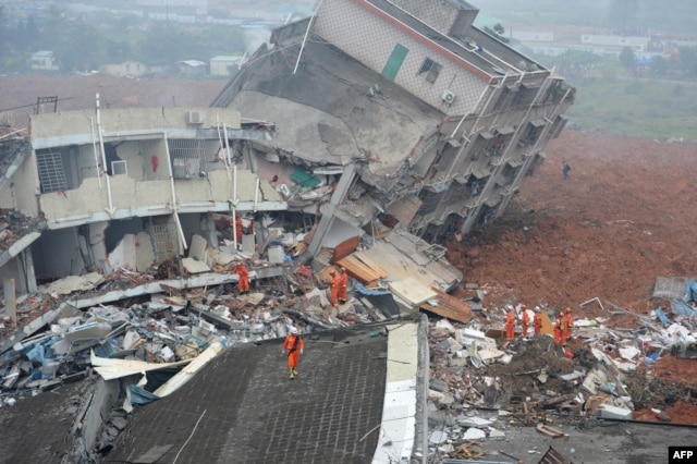 Rescuers look for survivors after a landslide hit an industrial park in Shenzhen, south China's Guangdong province on Dec. 20, 2015.