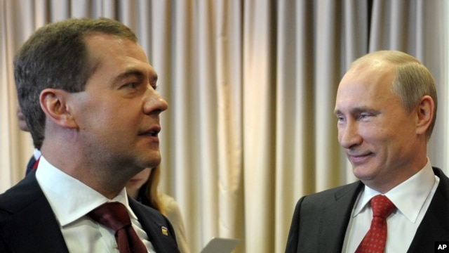 Russian President Vladimir Putin, right, and Prime Minister Dmitry Medvedev attend United Russia party annual congress, Moscow, May 26, 2012.