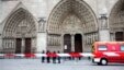Police officers stand guard in front of Notre Dame Cathedral, in Paris, Tuesday, May 21, 2013. Notre Dame has been evacuated after a man committed suicide in the 850-year-old monument and tourist attraction. (AP Photo/Thibault Camus)