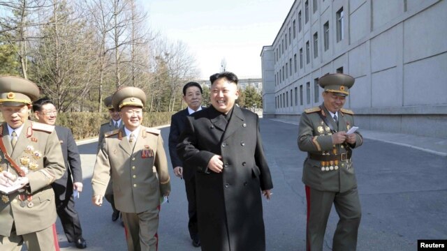 FILE - North Korean leader Kim Jong Un (C) visits the Kim Il Sung University in March 2014. Nobel Prize winners will visit the North's top universities to give speeches and hold workshops in May 2016.