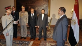 Egyptian President Mohammed Morsi swears in newly-appointed Minister of Defense, Lt. Gen. Abdel-Fattah el-Sissi, in Cairo, Egypt, Sunday, Aug. 12, 2012.