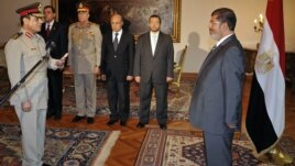 Egyptian President Mohammed Morsi swears in newly-appointed Minister of Defense, Lt. Gen. Abdel-Fattah el-Sissi, in Cairo, Egypt, Sunday, Aug. 12, 2012.