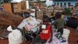 Zimbabwean children sit among salvaged possessions at a transit camp for over 100 families displaced by floods near the Tokwe-Mukorsi dam about 430km (267 miles) south of Harare, Feb. 13, 2014.