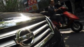 Japanese auto giants Nissan and Toyota said they would cut production in China because demand for Japanese cars has been hit by the diplomatic bitter row over disputed islands, Sept. 26, 2012..   