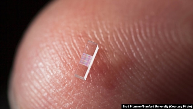 Particle accelerator on a nanostructured glass chip is smaller than a grain of rice. (Brad Plummer/Stanford University)