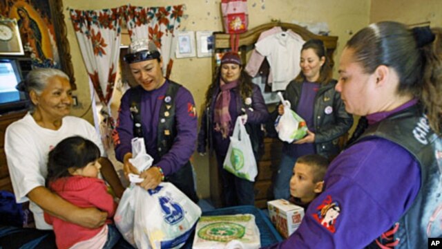 A group of Mexican women hand out aid in a low-income Ciudad Juarez neighborhood on Jan 23 201