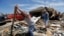 Chad Allcox, left, helps his friend Kevin McElvany, right, the home owner, clear debris away from his destroyed home from Monday's tornado, Moore, Oklahoma, May 22, 2013.