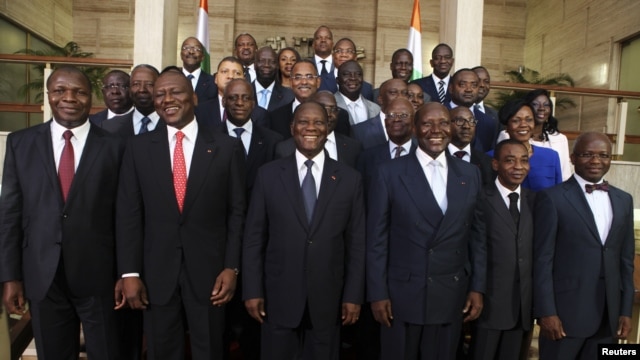 Ivory Coast's President Alassane Ouattara (C) poses with officials of his new government at the presidential palace in Abidjan, November 22, 2012. 