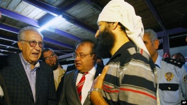 U.N. Syria envoy Lakhdar Brahimi, tasked with ending the 18-month conflict, left, speaks with refugees in Altinozu, Hatay, southern Turkey, Sept. 18, 2012.