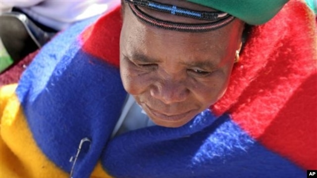 Elderly woman among thousands marching to government headquarters in festive re-enactment of famed anti-apartheid protest that addressed women's issues, Pretoria, August 2006.