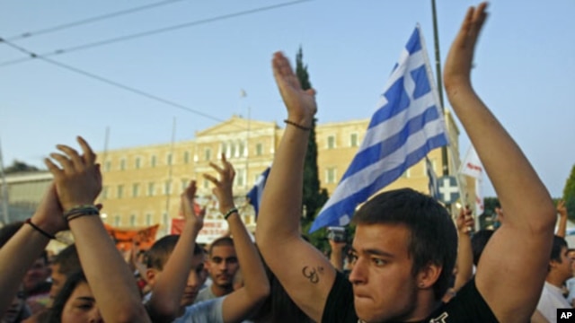 Protesters shout slogans during a rally against the austerity economic measures and corruption, in front of the parliament in Athens' Syntagma [Constitution] in Greece, June 23, 2011