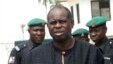 Diepreye Alamieyeseigha, centre, stands outside his house guarded by policemen in Yenagoa, Nigeria, in this file photo dated November 27, 2005.