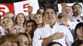 Georgia's President and leader of the ruling United National Movement party Mikheil Saakashvili gestures during the national anthem with his supporters during an election rally at a stadium in Tbilisi September 28, 2012. REUTERS/David Mdzinarishvili (GEOR