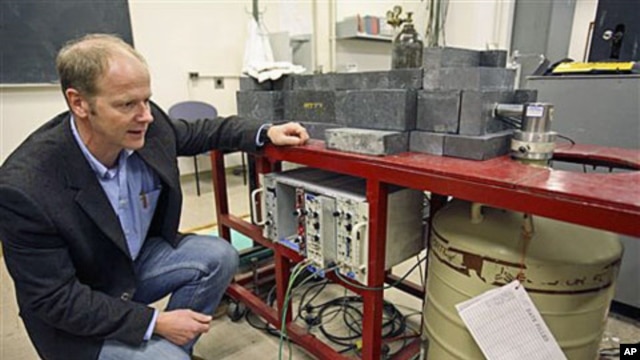 Professor Kai Vetter of the Department of Nuclear Engineering at the University of California at Berkeley kneels beside a germanium detector which is used to identify radioactive airborne particulates in a filter taken from air samples in Berkeley, Califo