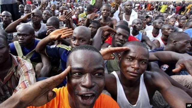 Youth supporters of Ivory Coast's Laurent Gbagbo gather at a stadium at army headquarters to sign up for military service in Abidjan, March 21, 2011