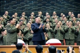 Military officials applaud with North Korean leader Kim Jong Un, during the Unhasu concert in Pyongyang, in a photo released April 16, 2013. (KCNA)