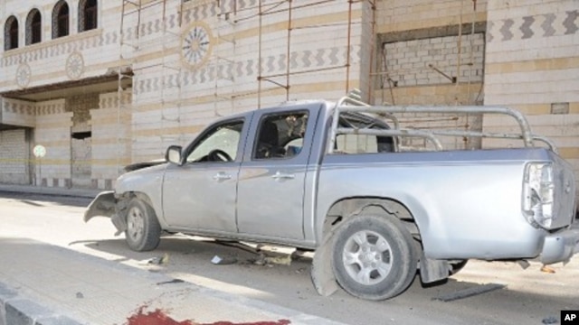 A photo released by SANA, the Syrian news agency, shows the aftermath of car bomb in Damascus, April 24, 2012.