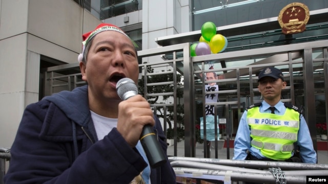 FILE - Pro-democracy lawmaker Lee Cheuk-yan speaks after releasing balloons with caricatures of jailed Chinese Nobel Peace Prize laureate Liu Xiaobo during a protest outside the Chinese liaison office in Hong Kong.