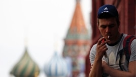 A man smokes a cigarette at Moscow's Red Square June 1, 2013. Russia has banned smoking at schools and universities, museums, sports facilities, hospitals and on public transportation. (FILE PHOTO)