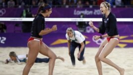 Kerri Walsh Jennings (R) and Misty May-Treanor of the US celebrate a point against Australia during women's beach volleyball match at 2012 Olympics