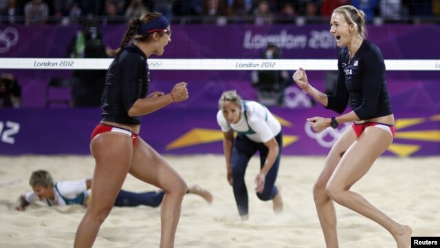 Kerri Walsh Jennings (R) and Misty May-Treanor of the US celebrate a point against Australia during women's beach volleyball match at 2012 Olympics