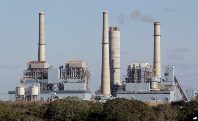 FILE- The Fayette Power Project, a coal-fired power plant, is shown in Ellinger, Texas, Dec. 15, 2010. Some environmentalists, ranchers and scientists linked tree deaths in the area to sulfur dioxide emissions from the plant.