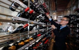 A manager looks at wines at the Marco Polo restaurant at the Grand Intercontinental Hotel in the Gangnam area of Seoul, South Korea, Oct. 2, 2012.