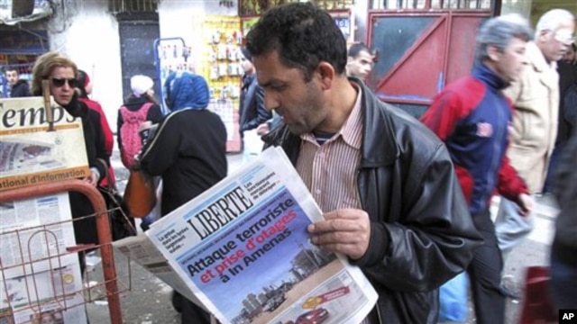 A man reads a newspaper headlining "Terrorist attack and kidnapping in In Amenas," at a news stand in Algiers, January 17, 2013. 