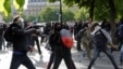 Masked youths face off with French police during a demonstration against the French labor law proposal in Paris, France, as part of a nationwide labor reform protests and strikes, April 28, 2016.
