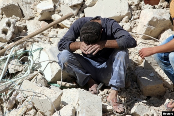 FILE - A man reacts on the rubble of damaged buildings after losing relatives to an airstrike in the besieged rebel-held al-Qaterji neighborhood of Aleppo, Syria, Oct. 11, 2016.
