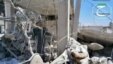 This citizen journalism image provided by Qusair Lens, which has been authenticated based on its contents and other AP reporting, shows a Syrian man checking his destroyed house that was damaged by a Syrian forces air strike in the town of Qusair, near th