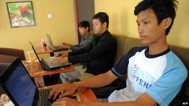 FILE - Cambodian men use the internet at a cofee shop in Phnom Penh.