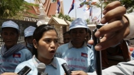 Cambodian protester Tep Vanny, center, talks with journalists after she and a group of others from Beung Kak lake submitted a petition to the National Assembly asking the government to return the title of their land, in Phnom Penh, Cambodia, Wednesday, May 2, 2012. (AP Photo/Heng Sinith)