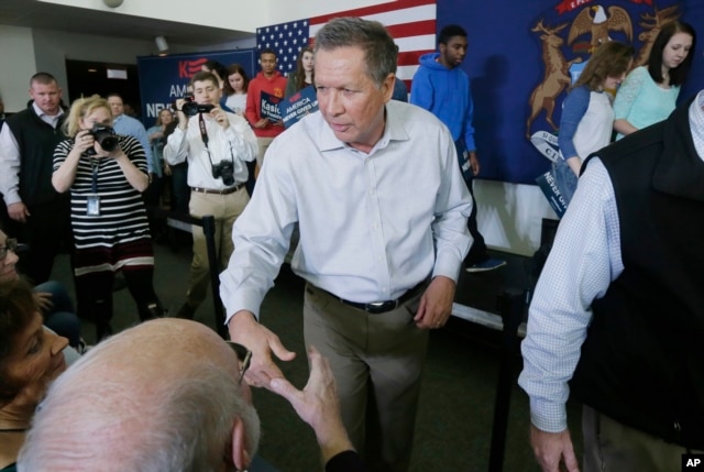Republican presidential candidate, Ohio Gov. John Kasich shakes hands after speaking at a rally at the Monroe County Community College in Monroe, Michigan, March 7, 2016.