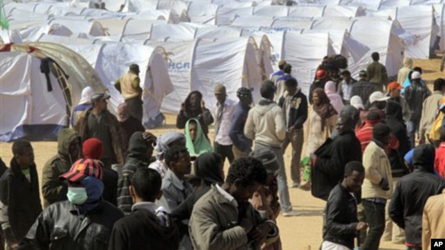 Migrant workers, who used to work in Libya and fled the recent unrest in the country, are seen in a refugee camp at the Tunisia-Libyan border, in Ras Ajdir, Tunisia, March 9, 2011. (AP Image)