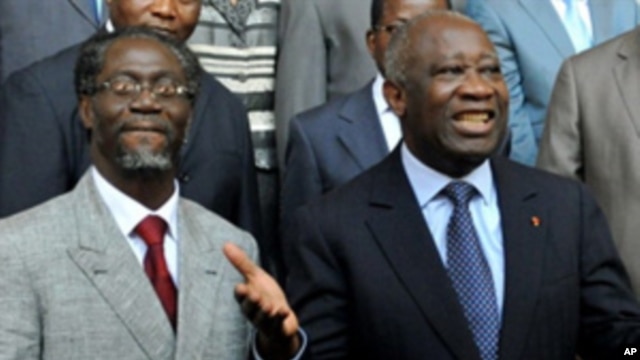 Ivory Coast's incumbent President Laurent Gbagbo (R) with Prime Minister Gilbert Ake N'gbo (L) and other ministers at the Presidential palace in Abidjan on December 7, 2010.