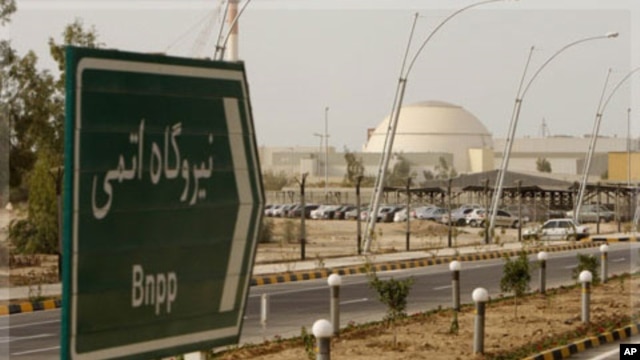 A sign reading "Atomic Power plant" points the way to the nuclear power plant in Bushehr, Iran,  Feb. 25, 2009.