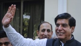Pakistan's Prime Minister Raja Pervez Ashraf waves to media in Islamabad, June 22, 2012. 